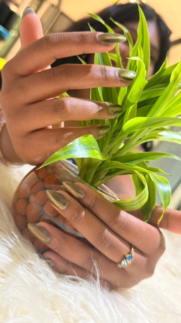 Metallic olive manicure shown in close detail
